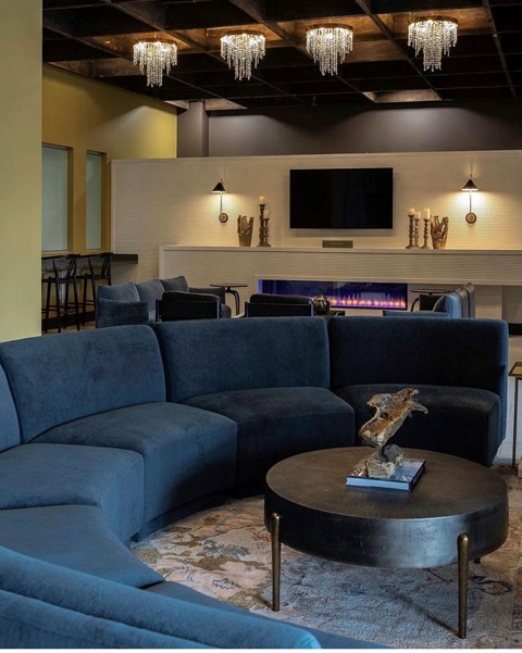 a living room with blue couches and a coffee table